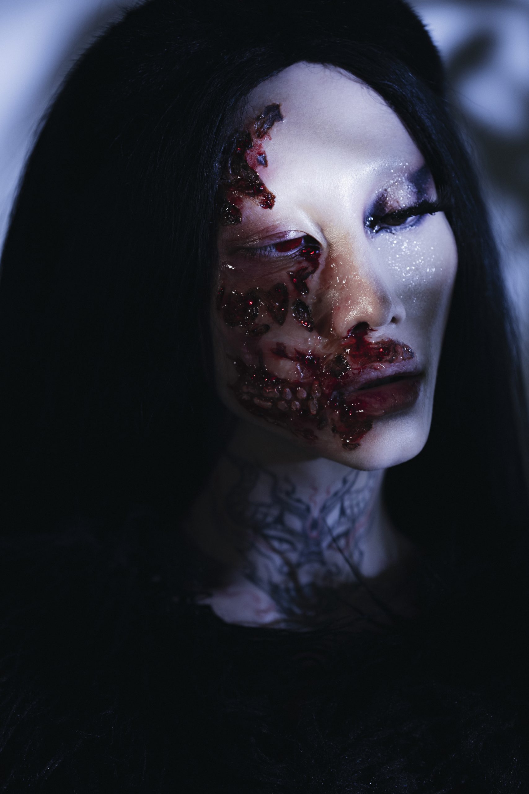 Woman with black hair and red fake wounds