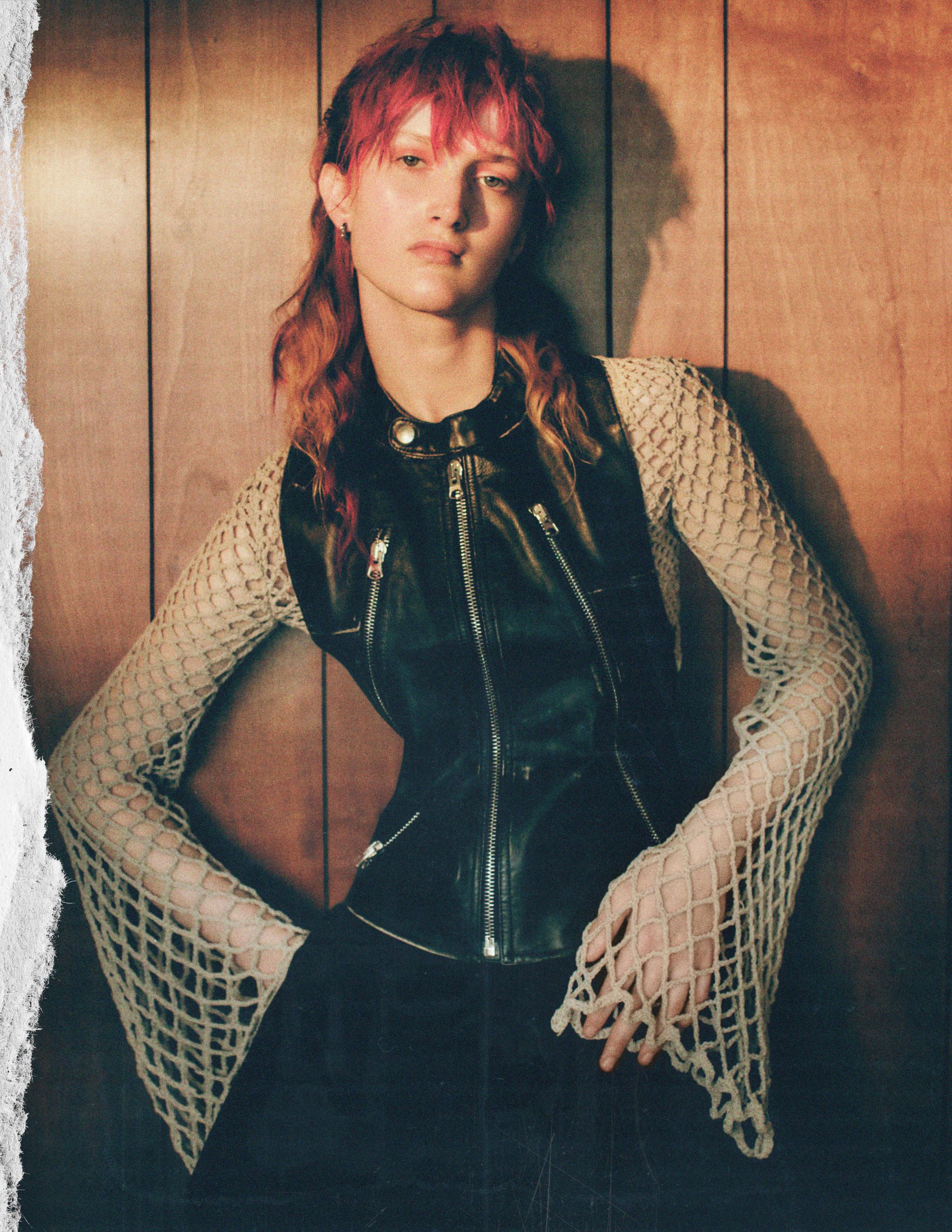 woman wearing a net shirt and leather gilet