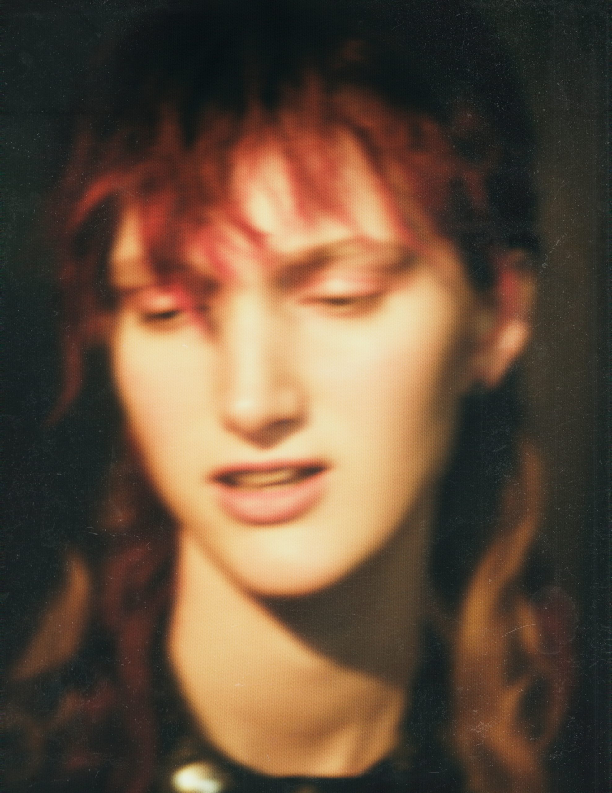 blurry portrait of a woman with red hair