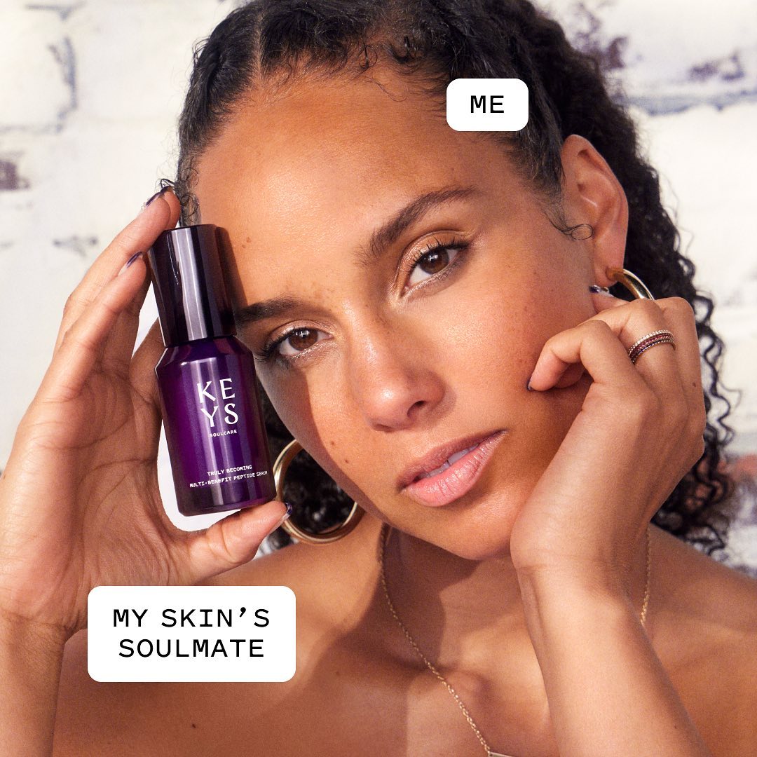 Alicia Keys holds her skincare product