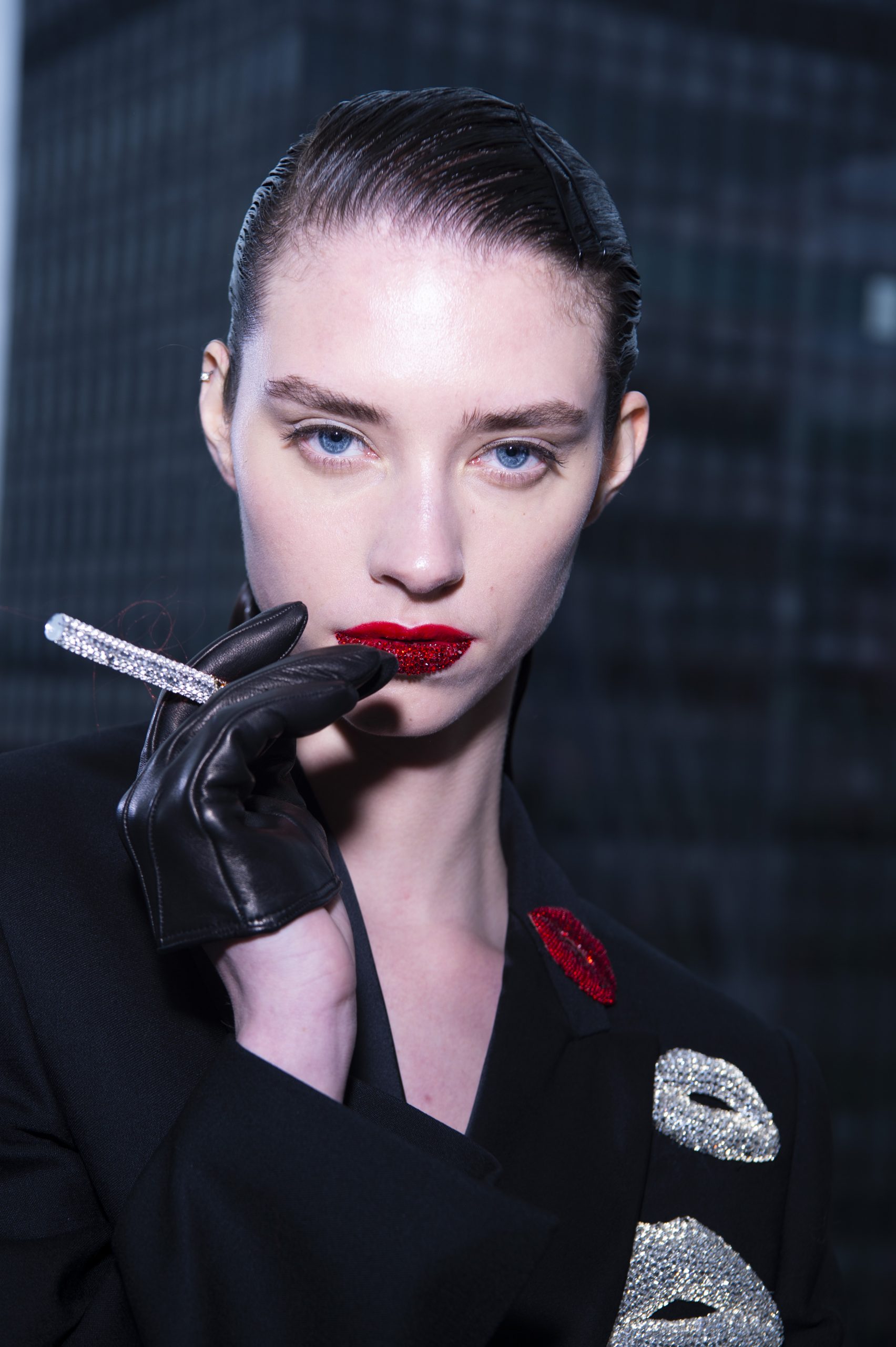 Model wearing red lipstick and leather gloves